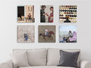 a white couch with 6 different rasmorawaj illustrations hanging on canvases 